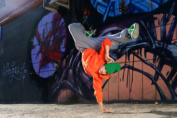 boy dancing on the street graffity wall
