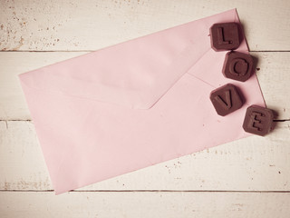 Chocolate Love with letter paper on the wooden background