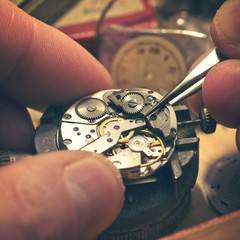 Working On A Mechanical Watch. A watch makers work top. The inside workings of a vintage mechanical...