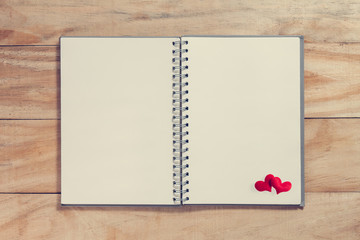 notebook with red heart on wood table ,Valentines background in