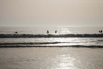 backlighting surfers waiting waves