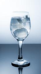 Wineglass with ice cubes