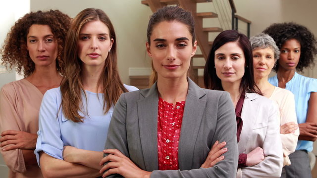 Serious women standing with arms crossed