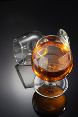 cognac and  glass  on black