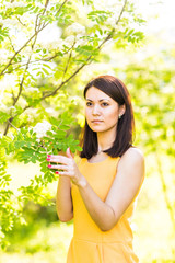 Portrait of young beautiful woman in spring blossom trees