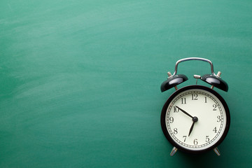 alarm clock on chalkboard