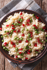 couscous with pomegranate close-up. vertical top view
