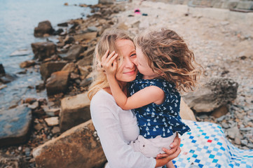 portrait of happy mother and daughter spending time together on the beach on summer vacation. Happy...