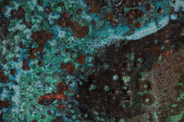Multicolored background: rusty metal surface flaking and cracking texture
