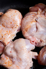 Chicken with spices fried in a pan