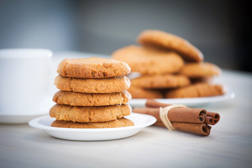 Fresh baked peanut butter cookies with cinamon sticks. Closeup with shallow depth of field.