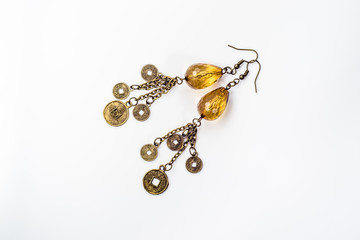 Handmade earrings jewelry made with antique gold and beads isolated on white
