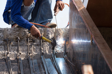 Fototapeta premium worker welding steel metal