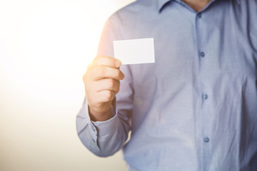 Man holding white business card 