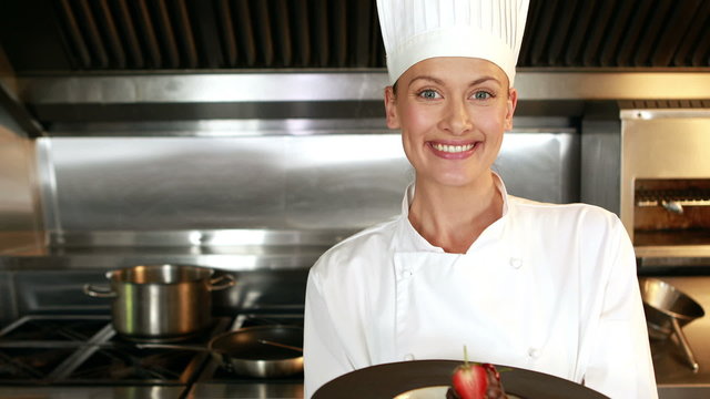 Smiling chef showing a plate