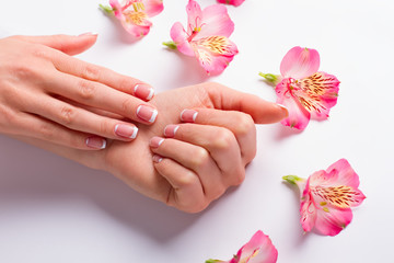Female hand with delicate flowers.
