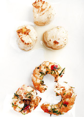Scallops and shrimps on white background