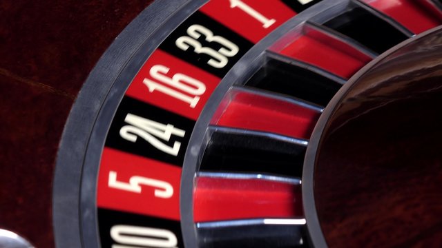 Roulette wheel running and stops with white ball on zero