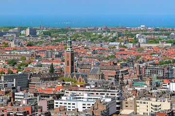 Fototapeta na wymiar High angle view of The Hague with Grote of Sint-Jacobskerk (Great St. James Church), Netherlands. View from the panoramic terrace on the 42nd floor Het Strijkijzer skyscraper with height of 132 m.