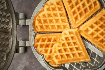 Home made heart shaped waffles served in a traditional cast iron waffle pan.