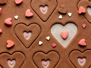 Preparation of cookies in form of heart on Valentine's Day. Beautiful festive background