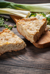 French Quiche Lorraine with ingredients on wood board