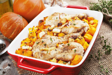 Chicken legs baked with pumpkin and garlic