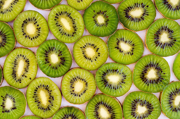 Bright green slices of kiwi fruit as a background