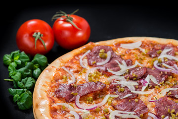 close-up of delicious pizza with mushrooms, ham and pickles on a