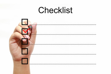 Businessman checking mark on checklist with marker over white