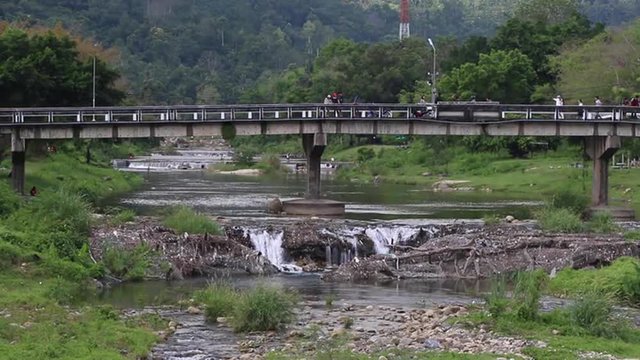 Tourist car cross the bridge by the waterfall