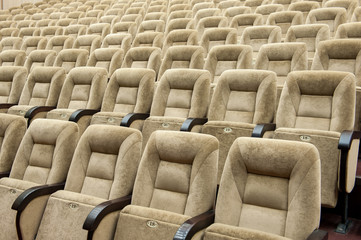 Empty auditorium with beige chairs, theatre or conference hall