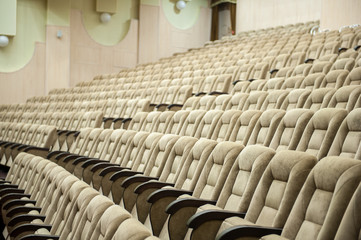Obraz premium Empty auditorium with beige chairs, theatre or conference hall