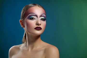 Magical beauty. Studio shot of a beautiful young female posing with colorful creative eye makeup copyspace on the side