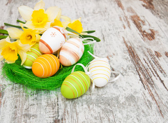 easter eggs in a nest with flowers