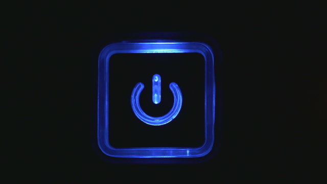 Male index finger pressing a power button