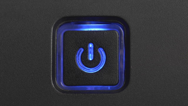 Male index finger pressing a power button