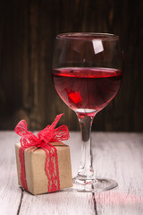 Gift box and glass of rose wine. Vintage style. Selective focus