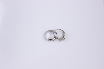 two silver diamond engagement rings isolated closeup