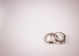 two silver engagement rings with diamonds, closeup