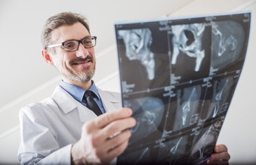 adult male doctor looking x-ray