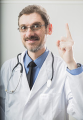 male doctor raised an index finger in the top as a sign of attracting attention