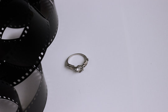 Photography film roll black isolated and diamond silver ring clo