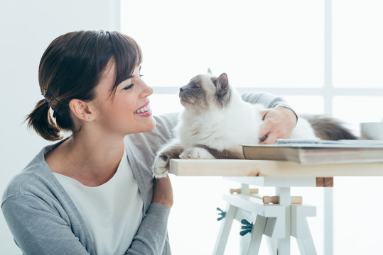 Happy Woman Cuddling Her Cat