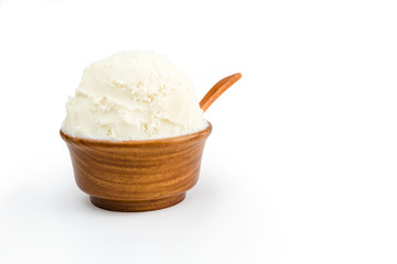Shea butter in the wooden bowl, clean white background.