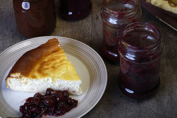 Slice of cheesecake on plate with jam