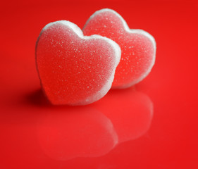 Sugar hearts on red background