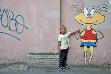 Fototapeta na wymiar Boy and graffiti on a wall