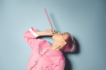girl have fun with colored balloons on blue background © pauchi