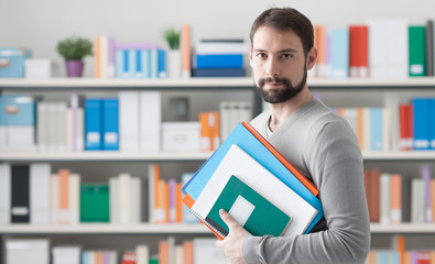 Man holding folders in the office
